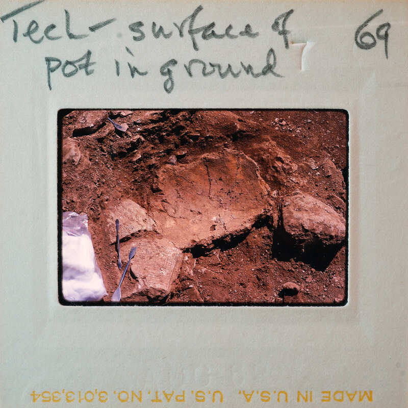 A photograph of a rock surface with handwritten notes on the border.