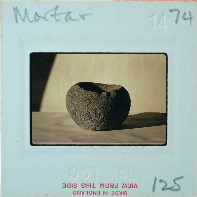 Profile of brown stone bowl on table.