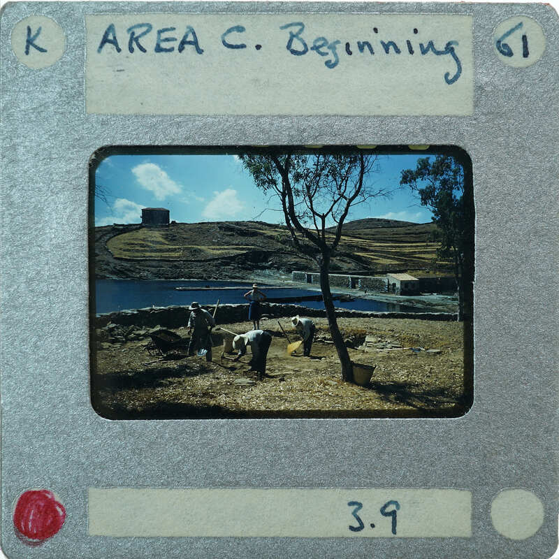 Photo of a person standing near water with mountains and trees, on film strip labeled "AREA C BEGINNING".