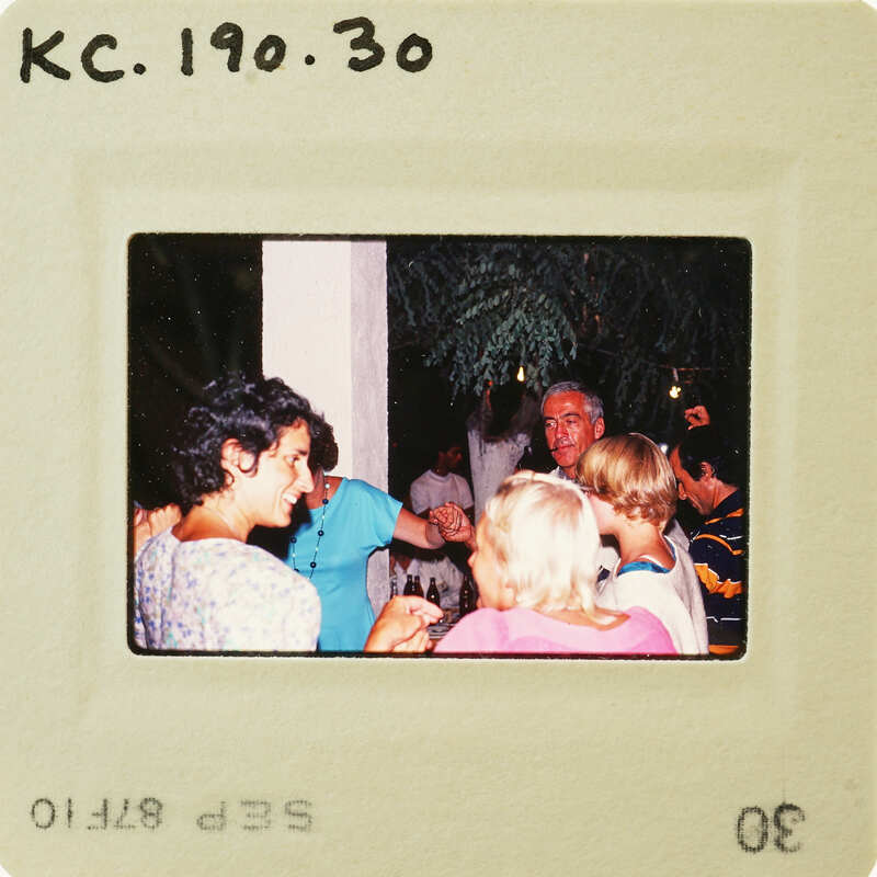 A group of people gathered together, smiling and enjoying each other's company.