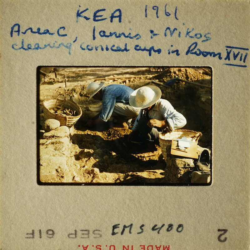Two men working on a construction project, possibly laying bricks or stones.