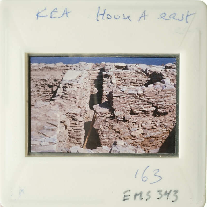 "Old photo of ruins with stone walls and blue sky."