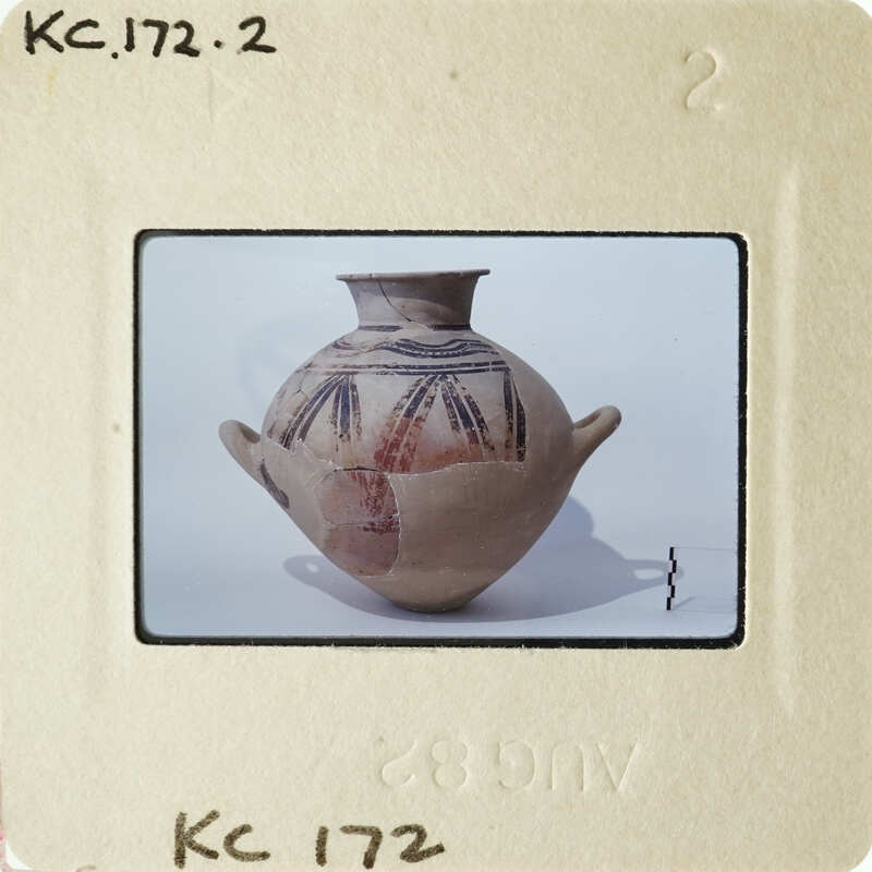 Ancient clay pot with intricate designs on a white background.