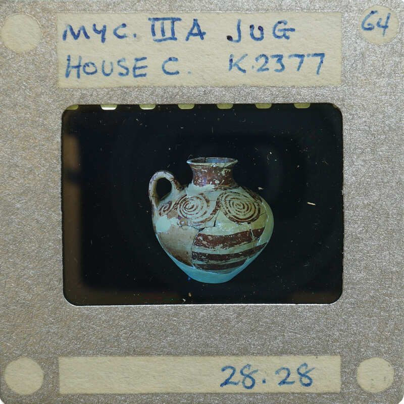 Reassembled lay jug with intricate design on black background K.2377.