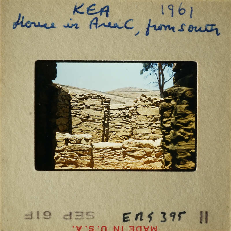 Old photograph of ancient ruins with stone structures and a clear sky.