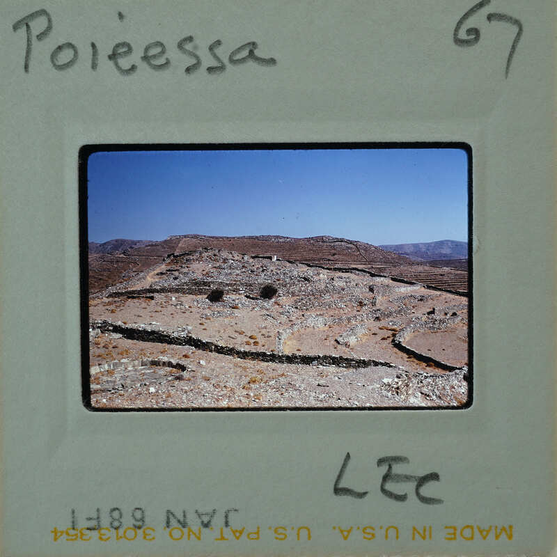 A photograph of an ancient archaeological site with stone ruins and a clear sky.