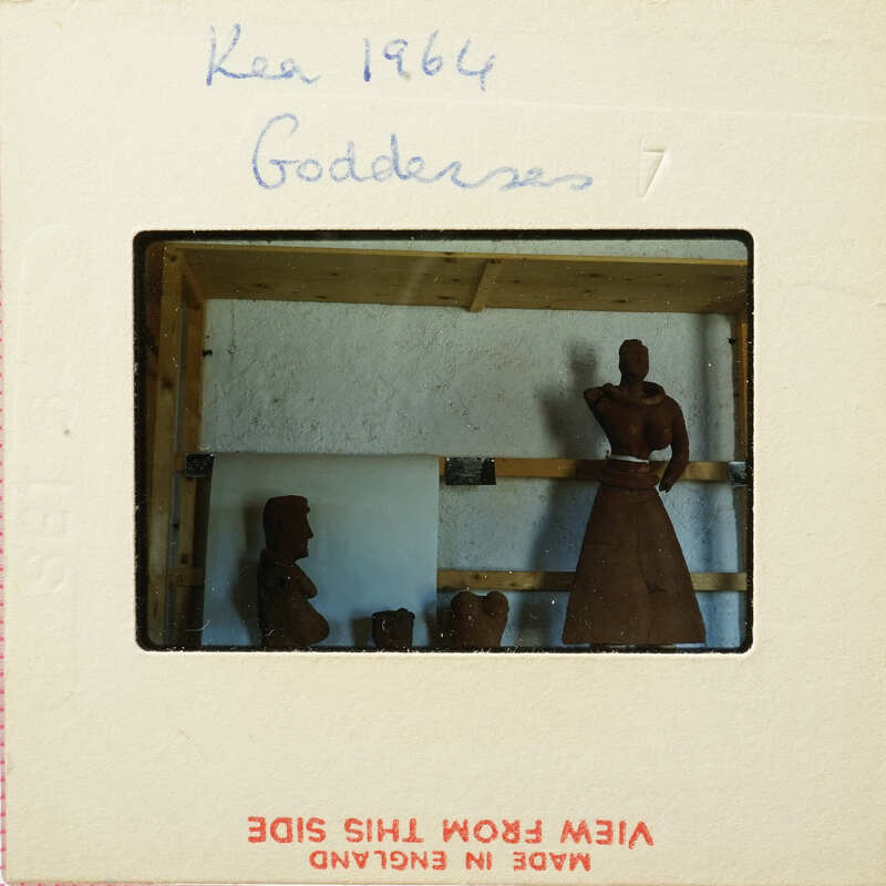 A photograph of an art exhibit featuring clay figurines, including a humanoid figure and other sculptures.