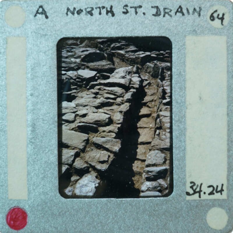 A photograph of a rocky path with a film strip label on it.