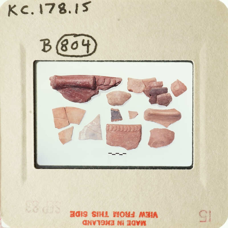 Broken pottery pieces on a white background.