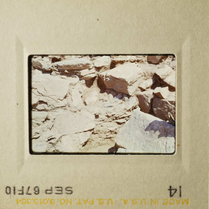 An image of a rocky landscape with a yellowish hue, possibly taken from an airplane window.