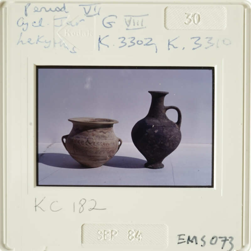 Two ancient vases on display, possibly at an auction or exhibition.