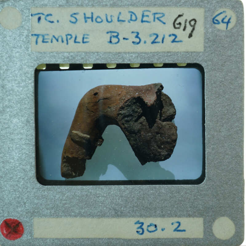 Terracotta fragments showing shoulder of figurine.