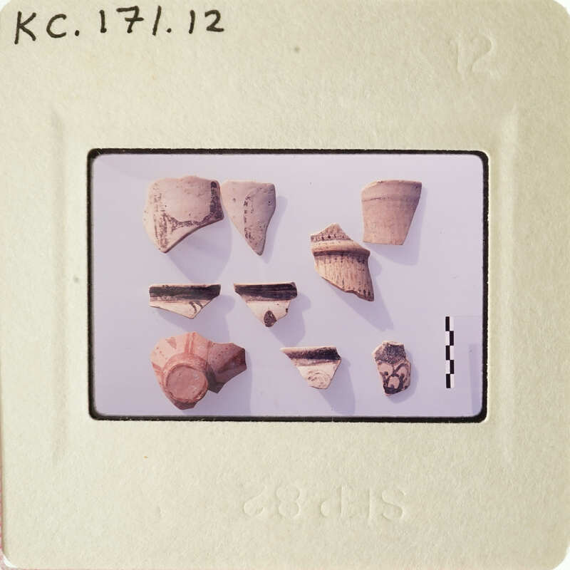 A collection of ancient pottery shards on display.