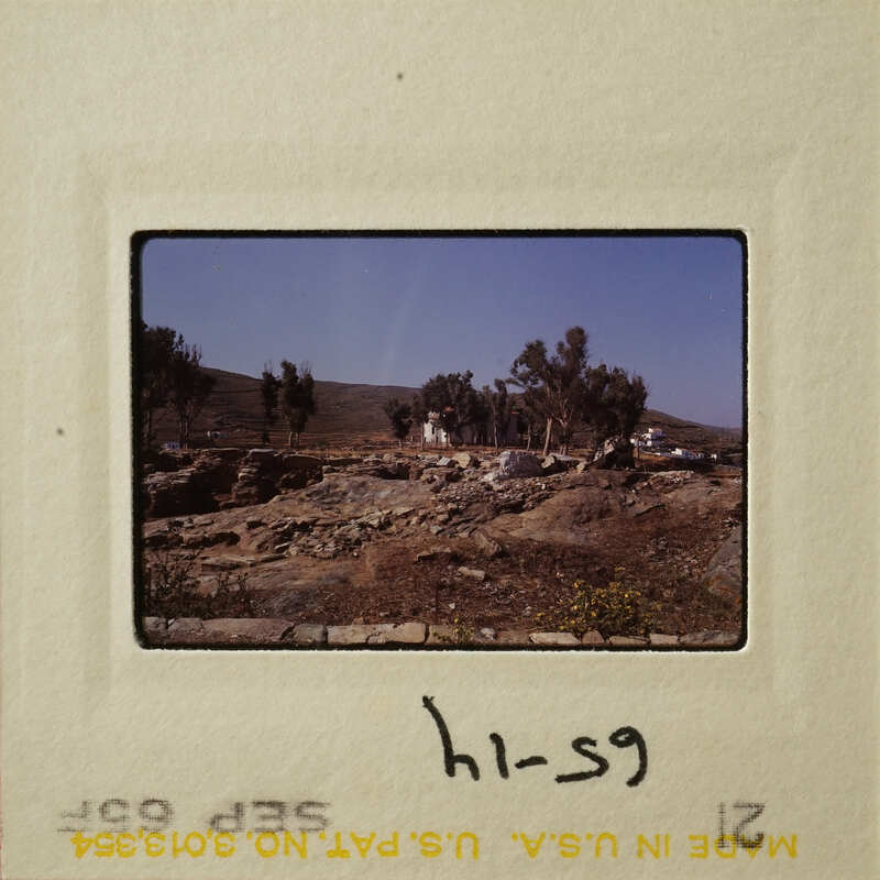A photograph showing an outdoor landscape with trees and rocks.
