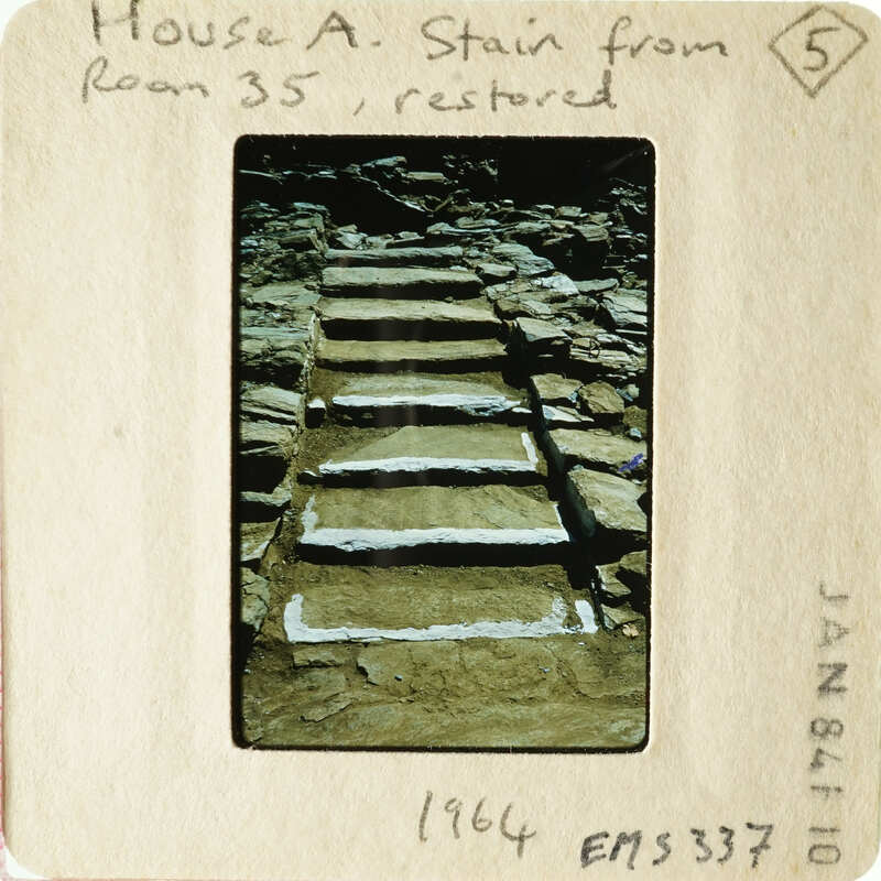 Old stone steps with worn treads, taken from an angle looking up.