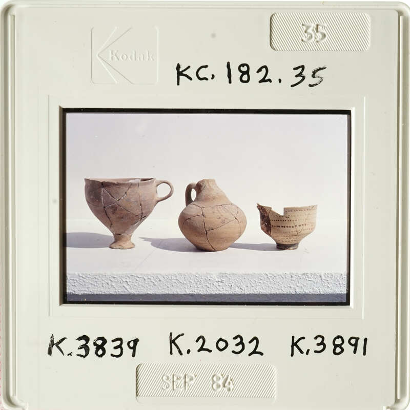 Old vases on display with visible cracks and wear, photographed against a white background.