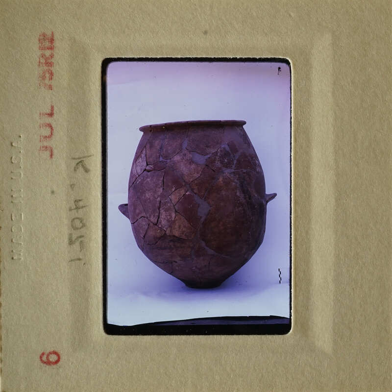 Old, cracked clay pot with visible layers and imperfections.