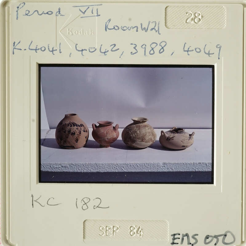 Row of four clay pots with varying sizes and designs.