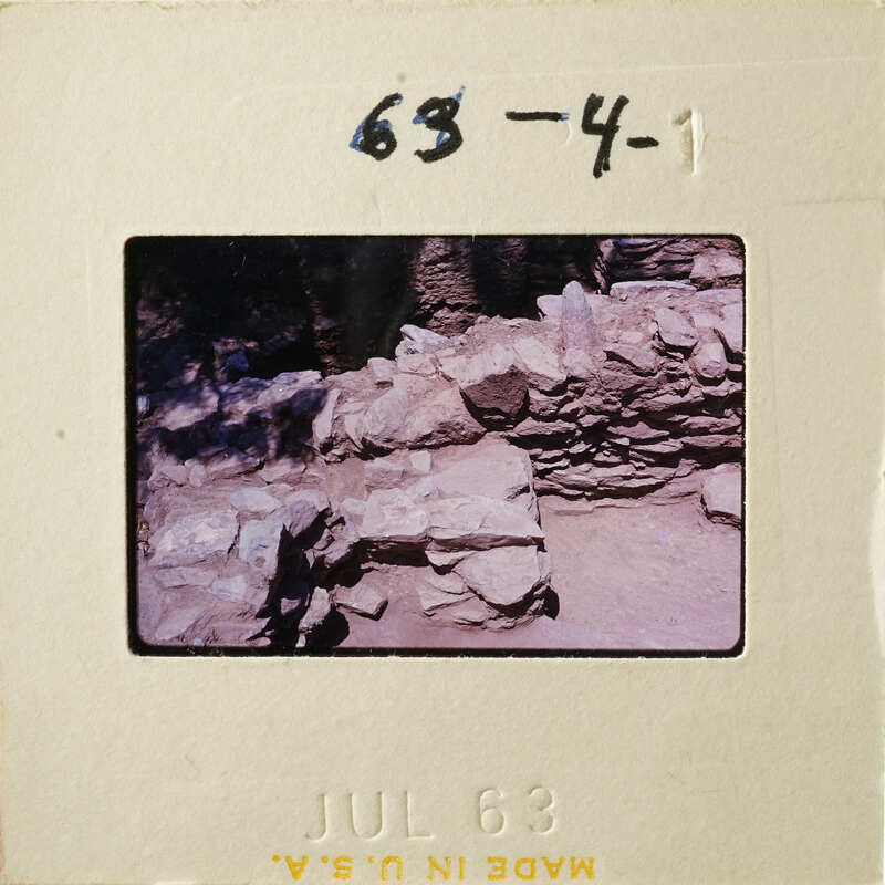 This is an old photograph depicting ruins with stone walls and vegetation, dated July 1983.