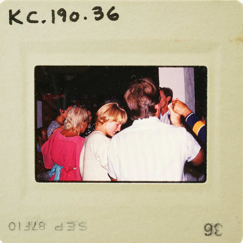 This is a vintage photograph of people gathered together, possibly at an event or party. Catalog number KC.190.36