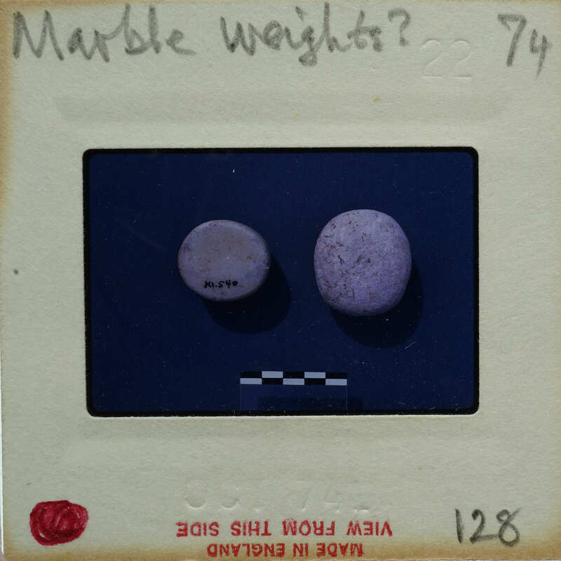 Two marble weights on a scale.