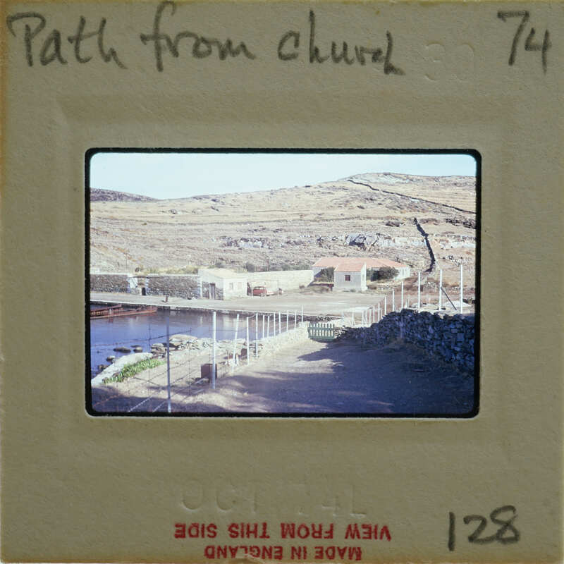 A vintage film strip with a photo of an outdoor scene, possibly near a church.