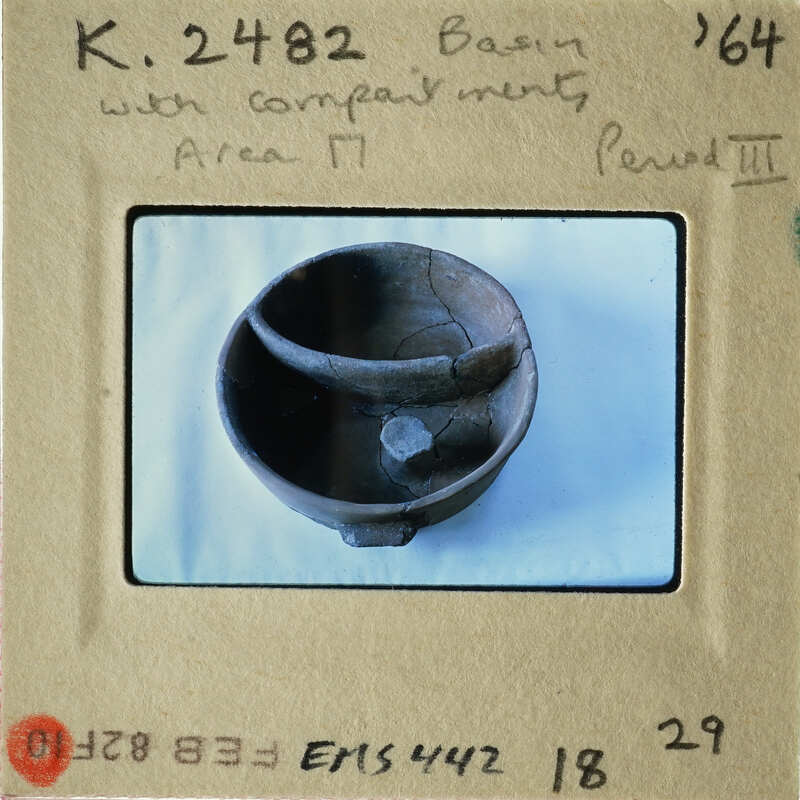 Old clay pot with cracks on display.