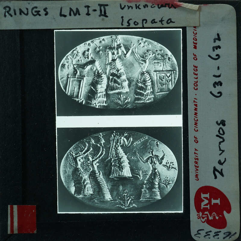 Black and white photograph of an ancient rings with a detailed design, placed on a light box.