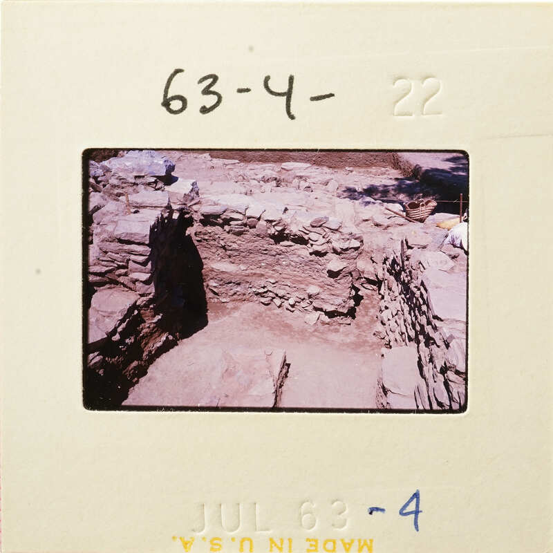 Ancient ruins with stone structures, possibly part of an archaeological site.