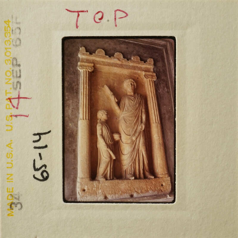 Ancient stone relief depicting two figures, possibly gods or mythological characters.