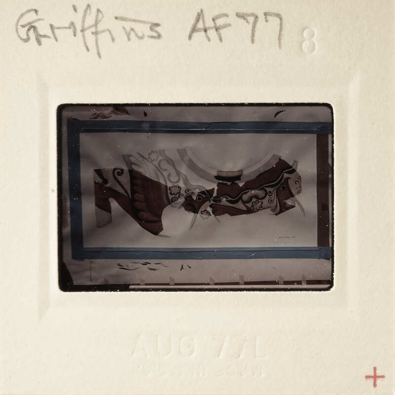 A vintage photograph of a person wearing traditional clothing, possibly from the 19th century, with handwritten annotations on its border.