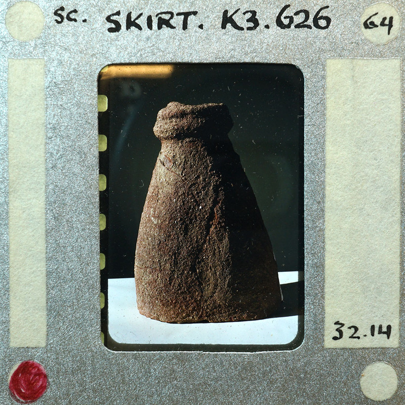 Partially reassembled terracotta figurine fragment of skirt K3.626.