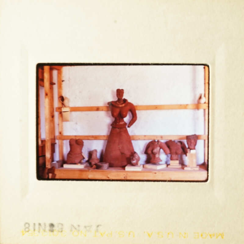 This is a photograph of a pottery studio with various clay sculptures on display.