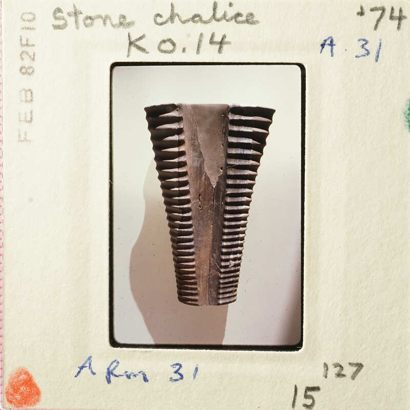 Old photograph of an ancient artifact, possibly a piece of pottery with a ridged texture.