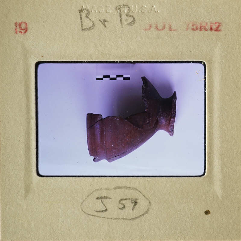 Ancient artifact displayed on a white surface.