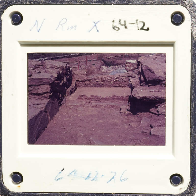 Ancient ruins with stone walls and pathways, captured on an old photograph.