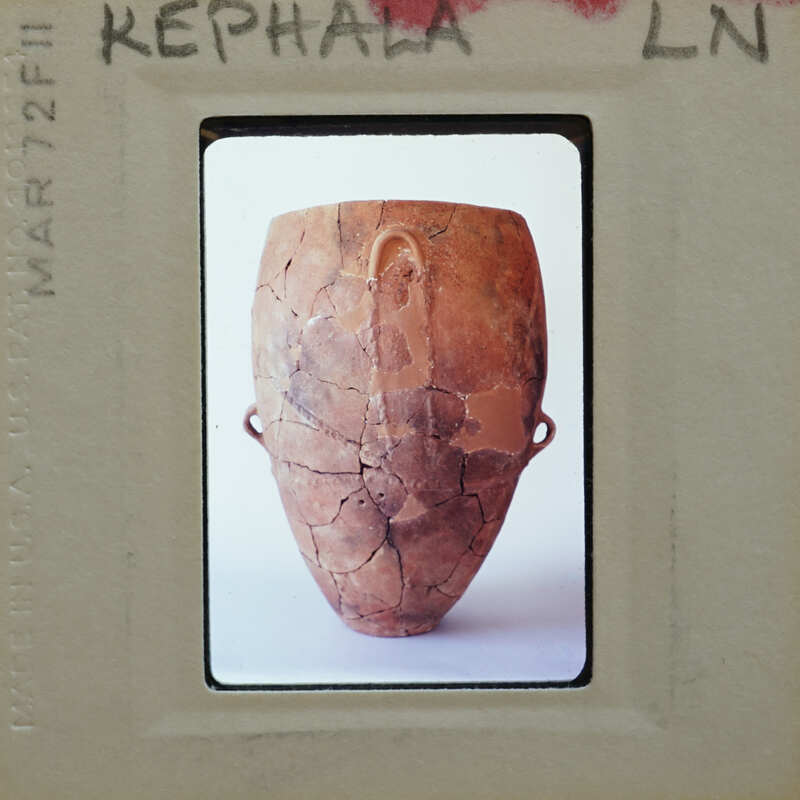 A photograph of a cracked brown clay pot with handles.