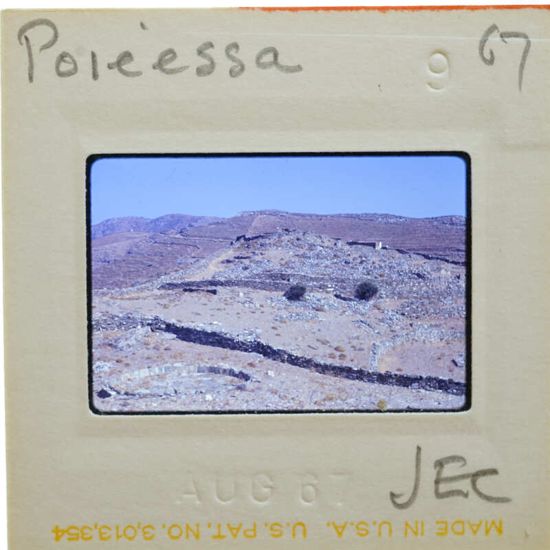 A slide showing a desert landscape with mountains and vegetation.