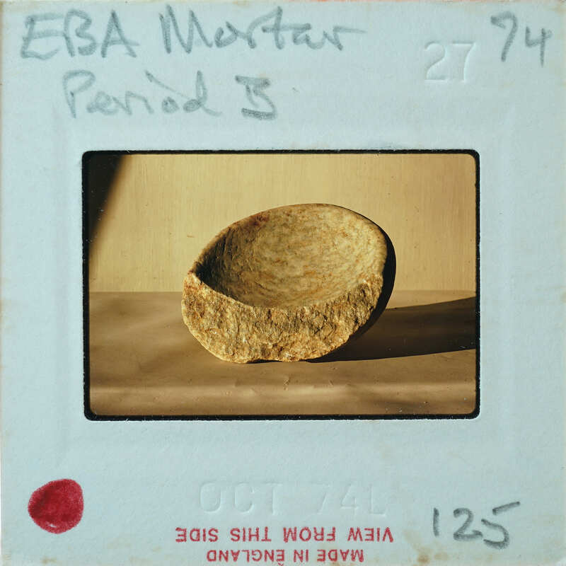 Most of a stone bow from the side showing break.