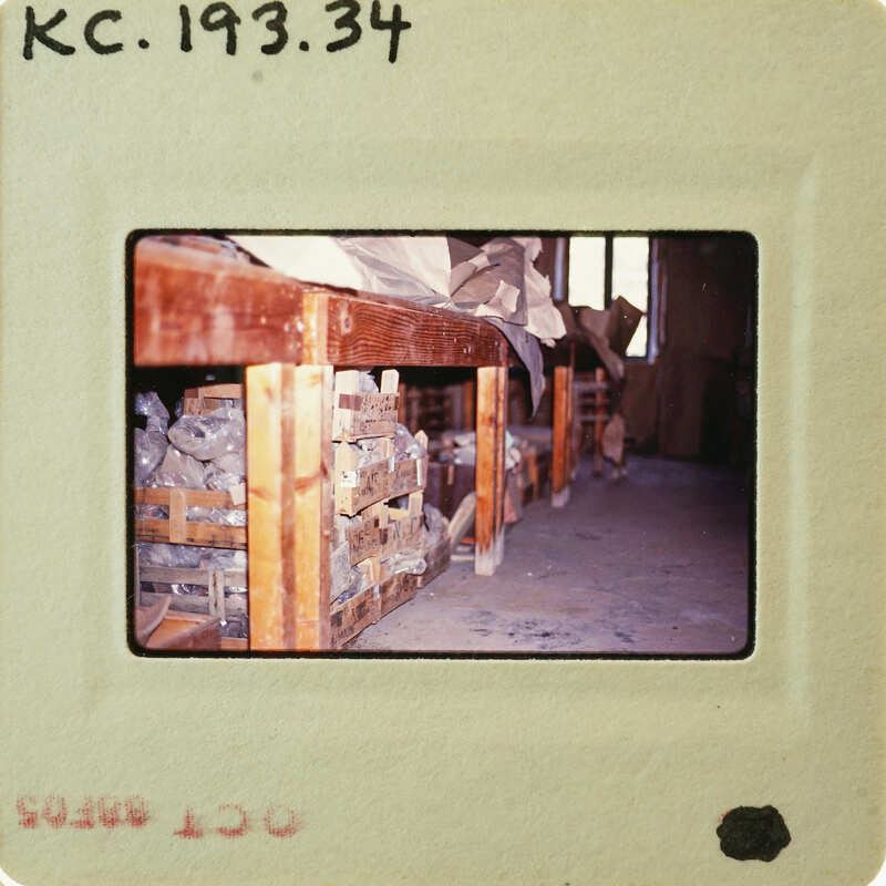 Photo of a wooden table with various items on it, taken from an old photograph and placed within another frame.