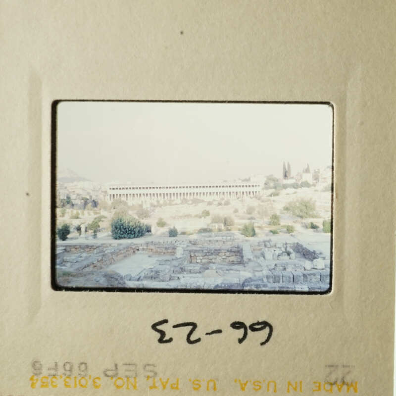 The image shows an ancient cityscape with old buildings, possibly ruins, and a clear sky above.