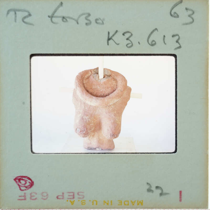 Image of a clay sculpture with a label and stamp on an envelope.