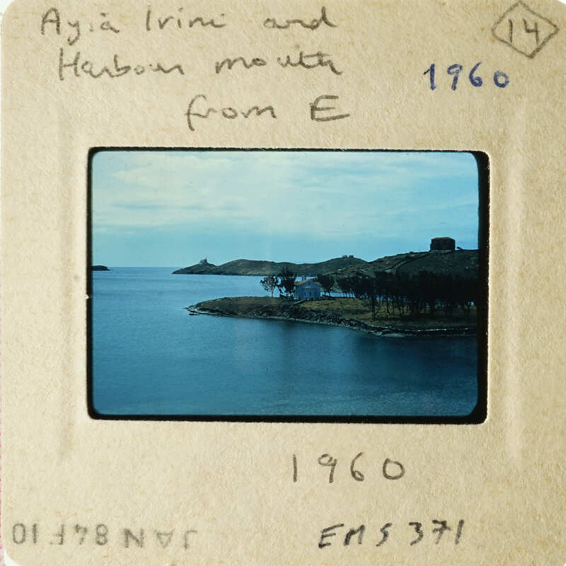 A vintage photograph showing a serene coastal scene with a body of water and an island.