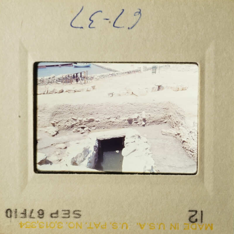 Old photographs of ancient ruins, likely taken with a film camera and displayed on a projector screen.