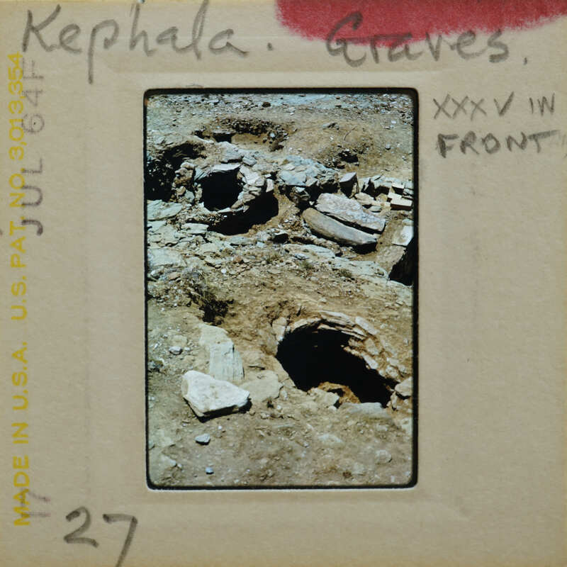 A photograph of an ancient archaeological site with excavated ruins and stone structures.