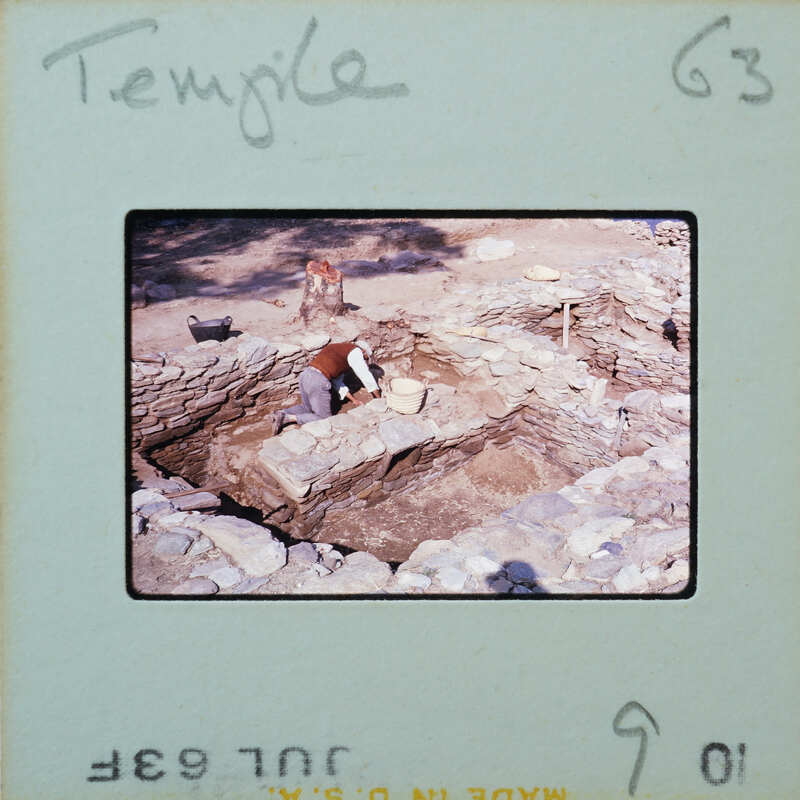 Stone walls with workman excavating.