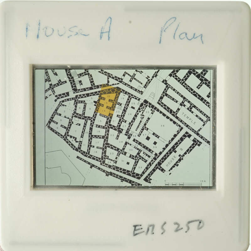 Aerial view of a city street with annotations, including a highlighted area and written notes.