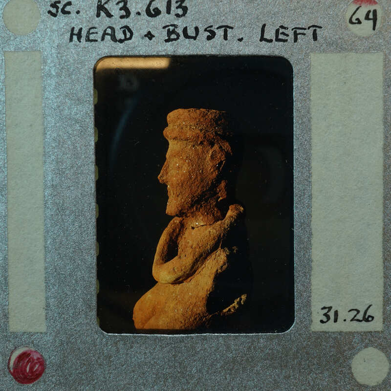 Terracotta figurine fragment (K3.613) from side showing head and torso in profile.