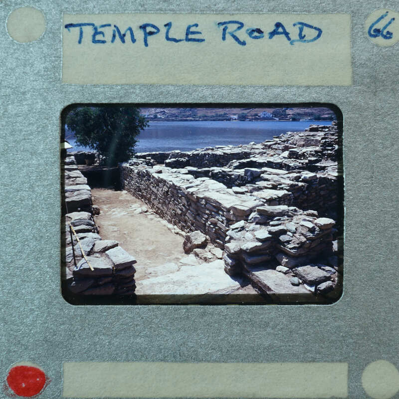 Parallel wall with surface between them and water in the background.