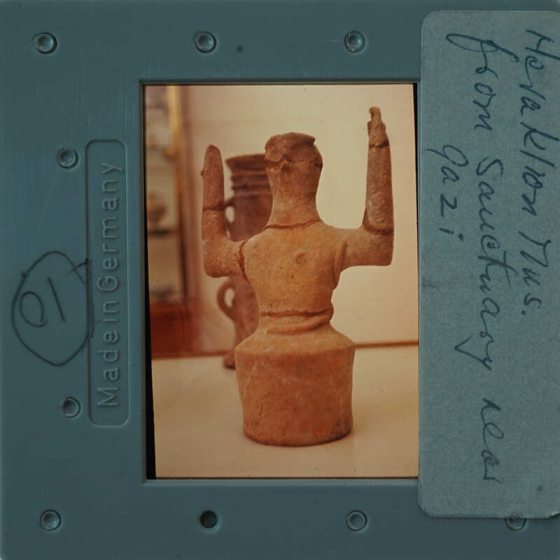 A small clay figurine of a person on display.